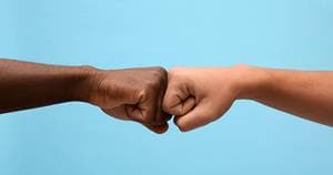 Men fist bumping