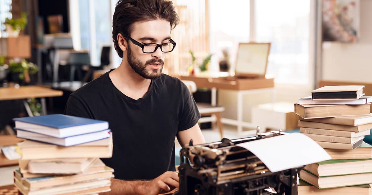 Man adding content to a typewriter