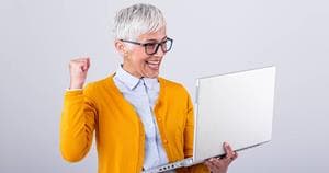 Happy older woman looking at a perfectly accessible website