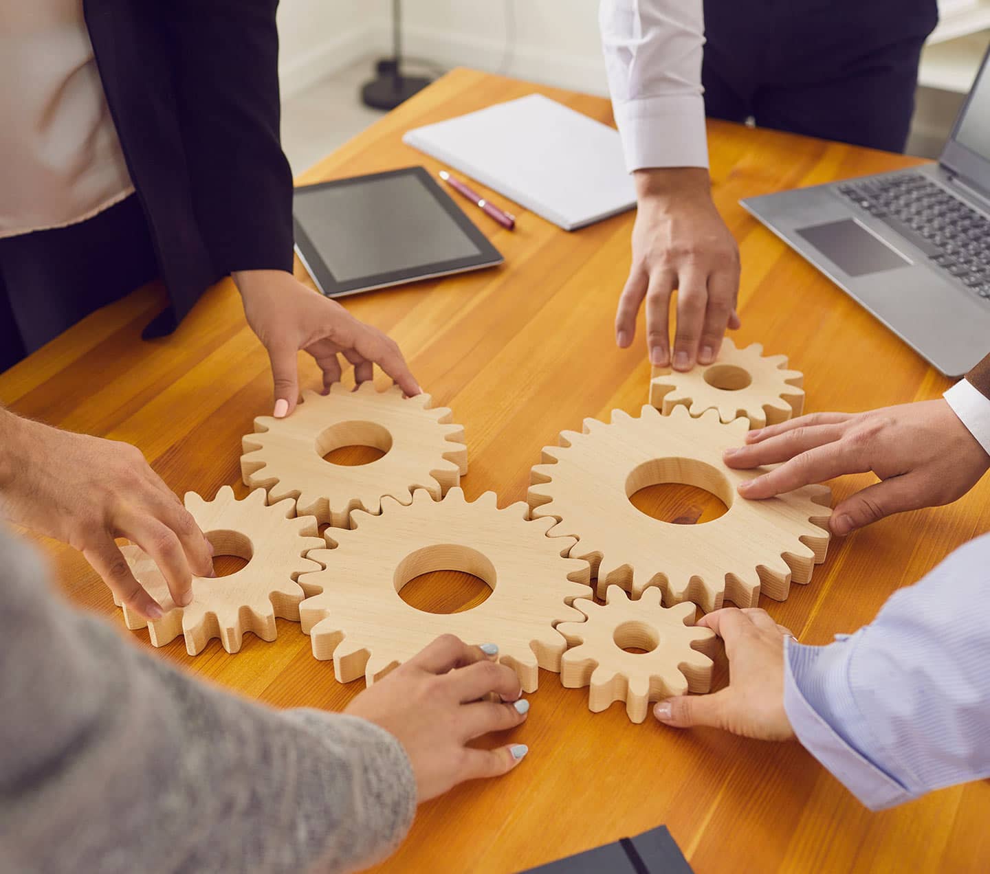 People joining cogwheels representing a "Solution"
