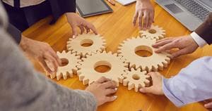 People joining cogwheels representing a "Solution"