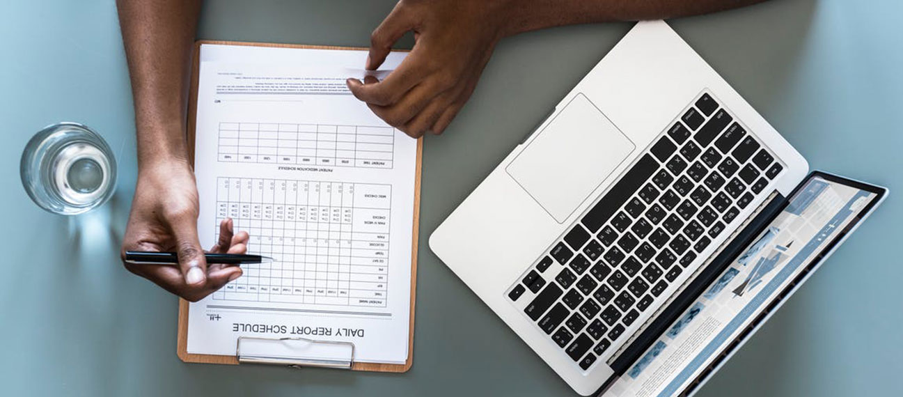 Man filling form, computer and water