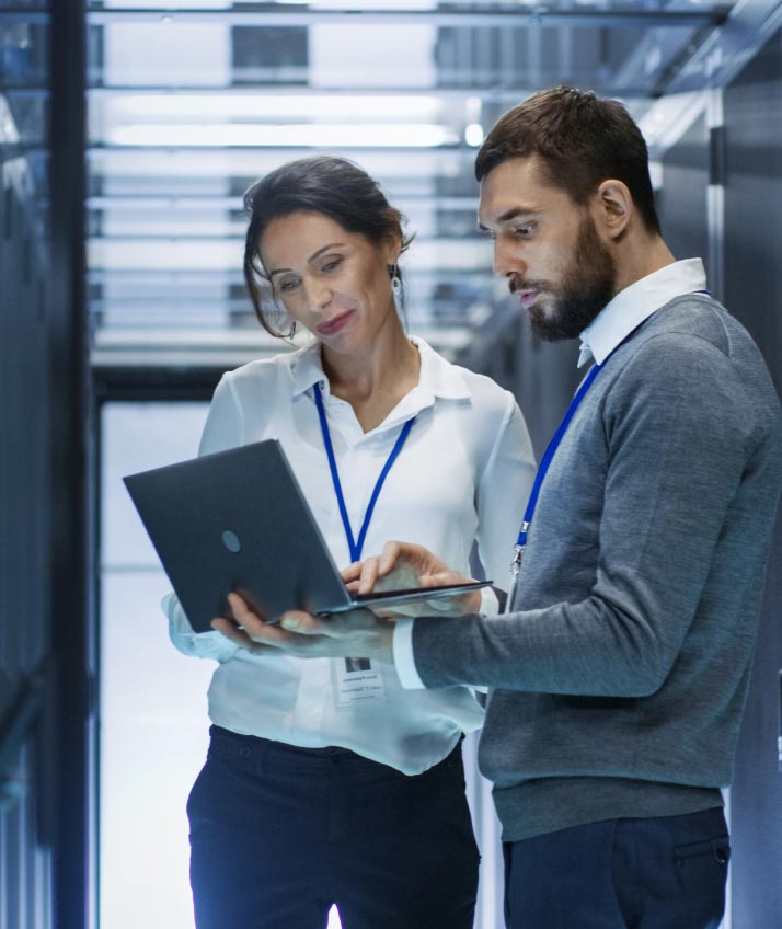 Man and woman in data center discussing their Sitecore migration